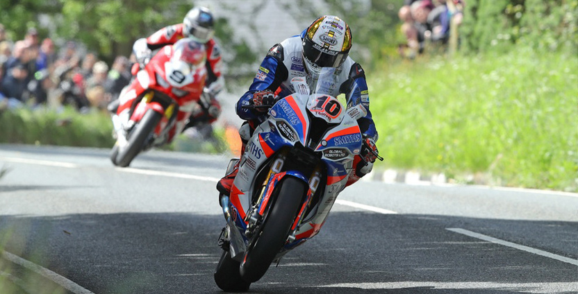 A man on a motorcycle races through the streets during the Isle of Man TT